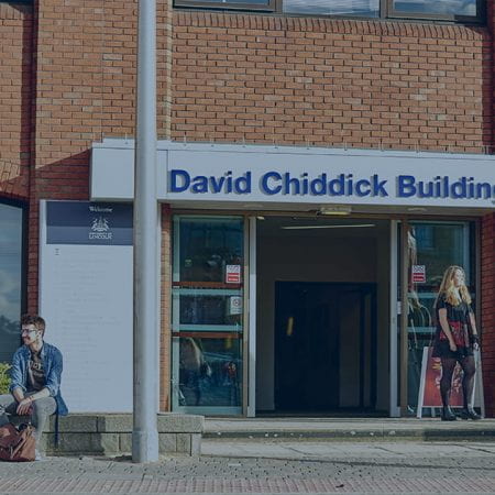 David Chiddick Building with students infront